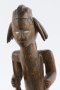 An African male fetish figure with gun and knife, carved wood, Babembe tribe, Congo area, on later wooden plinth, 28cm high overall - 6