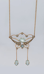 An Edwardian gold pendant set with aquamarines and seed pearls, stamped "15" with pictorial marks (illegible), later chain stamped "375, Italy", pendant 4.5cm high, 4.2 grams total