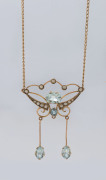 An Edwardian gold pendant set with aquamarines and seed pearls, stamped "15" with pictorial marks (illegible), later chain stamped "375, Italy", pendant 4.5cm high, 4.2 grams total