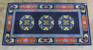 A Chinese woollen rug on navy blue background, 20th century, 173 x 92cm