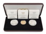 Gold : 1896-1996 Olympics Centenary three-coin presentation set celebrating "Friendship & Fair Play", comprising 22k gold $200 coin weight 16.97g, plus two sterling silver $20 coins, each weighing 33.63gr, in original presentation case with box; Unc.