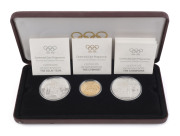 Gold : 1896-1996 Olympics Centenary, another example of this three-coin presentation set celebrating "Friendship & Fair Play", comprising 22k gold $200 coin weight 16.97g, plus two sterling silver $20 coins, each weighing 33.63gr, in original presentation