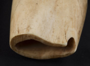 A scrimshaw whale's tooth decorated with Pacific Islander figures blowing conch horns, 17cm high - 10