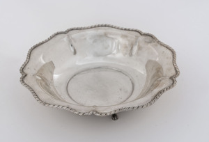 A German silver circular shaped bowl with gadrooned rim and raised on three paw feet, 20th century, 19cm diameter, 155 grams.