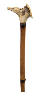 An antique walking stick, carved deer antler handle, cane shaft and later brass ferrule, 19th century, ​75cm high