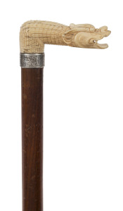 An antique walking stick with carved bone dragon handle, engraved silver collar, timber shaft and brass ferrule, 19th century, 79cm high