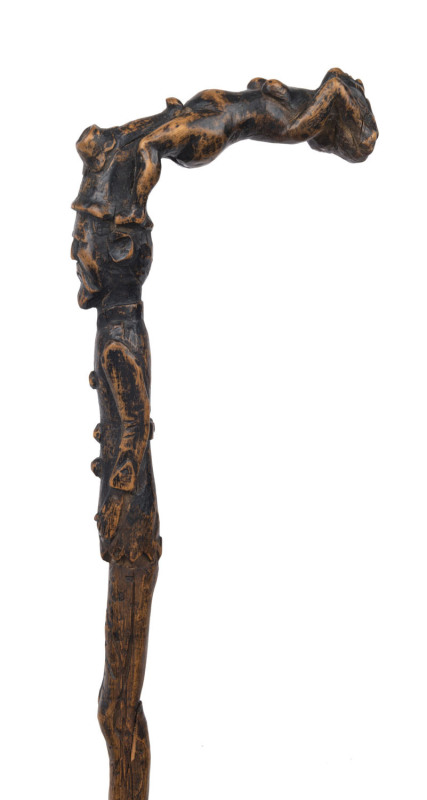 An antique walking stick profusely carved from top to bottom, with nude figural handle, male figure, assorted symbols, flowers and inscription (partially legible) plus metal ferrule, 19th century, 85cm high