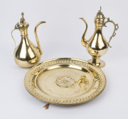 Two Middle Eastern brass coffee pots and a circular brass plaque, 19th century, (3 items), the plaque 45cm diameter