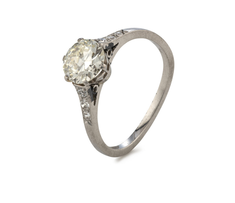 A stunning diamond and white gold engagement ring, set with a 1.1ct plus central stone flanked by three brilliant cut diamonds on each shoulder,