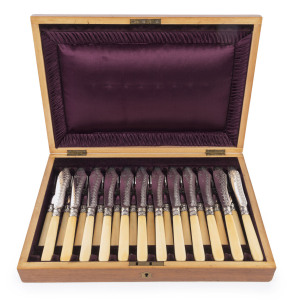 An antique fish cutlery service for twelve, engraved silver plate with ivory handles, housed in a fine walnut canteen with plush fitted interior, 19th century, the canteen 38cm wide