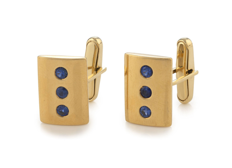 A pair of 14ct yellow gold cufflinks each set with three sapphires, stamped "14k", ​16 grams total