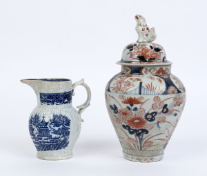 An antique Chinese "Willow" patterned sparrow beak jug together with an Imari lidded urn, 18th and 19th century, (2 items), both restored, 14.5cm and 27cm high