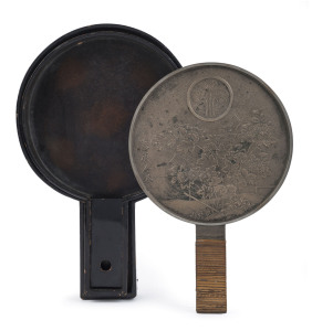 A fine Japanese bronze hand mirror with original cane handle and lacquered box, Meiji period, 19th century, ​27.5cm high, 18cm wide