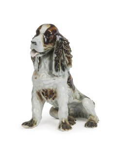 A Hungarian porcelain statue of an English Springer Spaniel, early 20th century, 34cm high, 37cm long