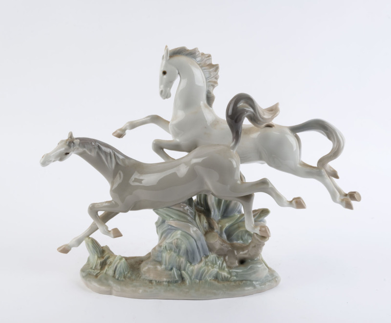 LLADRO Spanish porcelain galloping horses statue, 20th century, blue factory mark to base, 30cm high, 37cm long