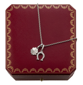 CARTIER 18ct white gold necklace with horseshoe and shamrock charms, stamped "Cartier, 750", with original Cartier receipt for £690 purchased at Selfridges London. ​42cm long, 15 grams