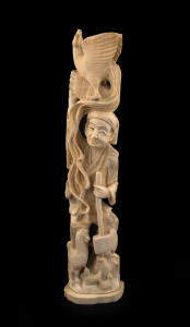 A Japanese carved marine ivory figural group of a man with a rooster on his head, Meiji period, 31cm high