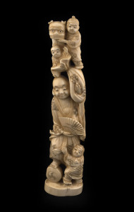 A Japanese carved marine ivory figural group of a man and children, Meiji period, 28cm high