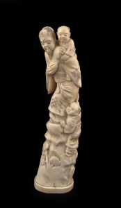 A Japanese carved marine ivory figural group, Meiji period, ​26cm high