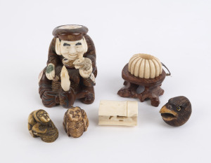 A group of seven Japanese netsukes, ornaments and carvings, ivory, bone and wood, 19th and 20th century, the largest 9cm high