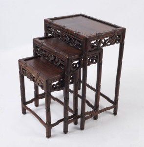 A nest of three Chinese carved rosewood occasional tables, early 20th century, 61cm high, 45cm wide, 32cm deep