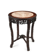A Chinese carved timber occasional table, late 19th century, 76cm high, 64cm diameter