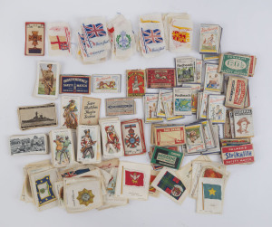 SILKS & MILITARY CARDS: assortment with silks mostly military ensigns/standards or flags; cigarette/trade cards part sets and odd cards incl. Havelock War Pictures, fighting ships; also quantity of matchbox labels. (qty)