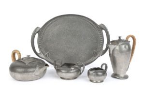A Liberty & Co "TUDRIC" pewter tea set and oval tray, designed by Archibald Knox, early 20th century, comprising a hand beaten teapot, hot water jug, sugar bowl and milk jug, plus a tray, stamped "Tudric, Made in England" 17cm high, the tray 36 x 25cm