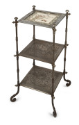 An English Arts & Crafts three tier wotnot, nickel plated cast metal with cockatoo motif and inset tile top, 19th century, 80cm high, 42cm wide, 42cm deep