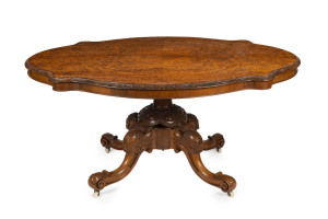 An Irish burr walnut centre table, handsomely carved with scrolling foliate motif, circa 1870, purchased from Acorn Antiques, Melbourne, ​73cm high, 156cm wide, 117cm deep