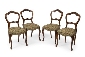 A set of four English carved walnut chairs with floral tapestry seats, circa 1875