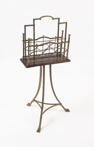 A revolving brass and timber newspaper stand, circa 1895, ​83cm high, 35cm wide, 30cm deep