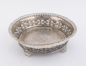 A Portuguese silver pierced circular dish raised on four feet, marked "833", 7.5cm high; 24.5cm diameter; 415gms.