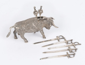 A Mexican silver miniature figure of a bull with six sword shaped cocktail skewers, mid 20th century, 55 grams total