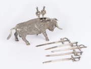 A Mexican silver miniature figure of a bull with six sword shaped cocktail skewers, mid 20th century, 55 grams total