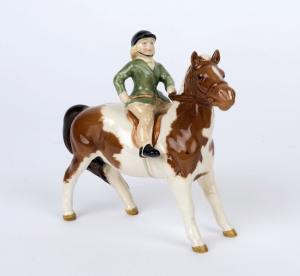 BESWICK porcelain statue of a girl riding a pony, black factory mark to underside, 14cm high, 15cm wide