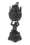An antique Tibetan bronze censer with dragon finial and figural devil stand, 18th/19th century, 31cm high