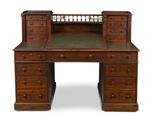 An antique English oak twin pedestal Dickens desk with two banks of Wellington drawers on the top and original brass sconce candle holders, 19th century, 117cm high, 150cm wide, 76cm deep