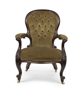 An antique English Gentleman's armchair with finely carved walnut frame and green velvet button back upholstery, circa 1870, ​72cm across the arms