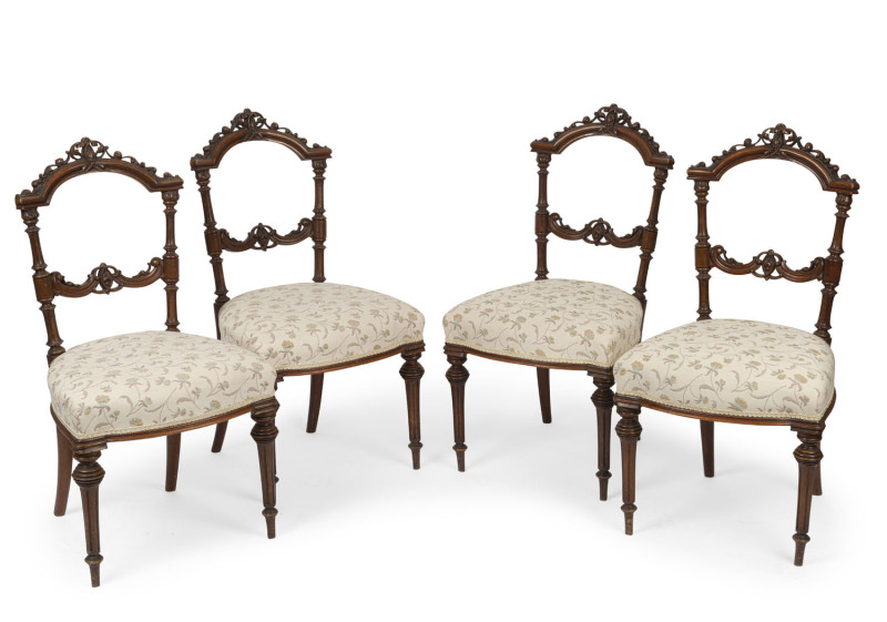 A set of four antique French carved walnut dining chairs with cream floral upholstery, circa 1875