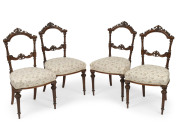 A set of four antique French carved walnut dining chairs with cream floral upholstery, circa 1875