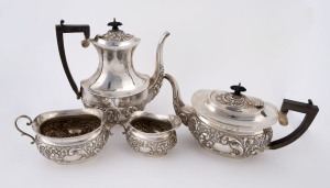 An English four piece sterling silver tea service made in Birmingham, circa 1905, the largest 26cm high, total weight including handles 1625 grams