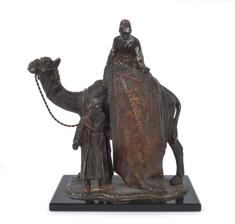 An Austrian cold patinated spelter table cigar lighter depicting two Arabs and a camel, circa 1900, ​19cm high