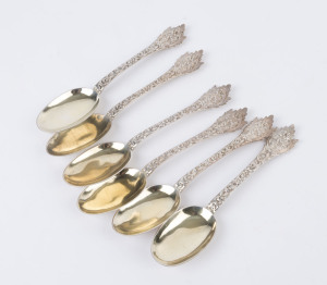 A set of six sterling silver spoons by Henry William Curry, London, 1878, in the Aesthetic style, each cast depicting flowers and scrolls in relief with an anointing scene to each handle. (6 items). Total weight: 445gms.