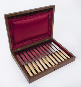 An antique English boxed fruit cutlery set for twelve, finely engraved blades and collars with bone handles in original plush fitted walnut box, 19th century