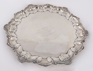A sterling silver platter raised on three feet, by Frank Hawker Ltd., Birmingham, circa 1969. With engraved dedication "Presented to Miss Kathleen Syme, O.B.E. by The Directors of David Syme & Co. Limited on the occasion of her retirement from the Board of Directors on 15th February 1971 in recognition of a lifetime of service to THE AGE". 1100 grams.
