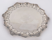 A sterling silver platter raised on three feet, by Frank Hawker Ltd., Birmingham, circa 1969. With engraved dedication "Presented to Miss Kathleen Syme, O.B.E. by The Directors of David Syme & Co. Limited on the occasion of her retirement from the Board o