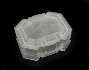 A French Art Deco frosted glass jewellery box, circa 1930, original foil label to base, ​4.5cm high, 9.5cm wide, 7cm deep