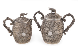 An Indian silver sugar bowl and jug adorned with animals in foliate motif and elephant finials with raised trunks, 19th century, (2 items), 12cm and 15cm high, 890 grams total