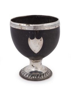 A Georgian silver mounted coconut bowl with gadrooned silver base and shield plaque, 18th/19th century, ​12.5cm high
